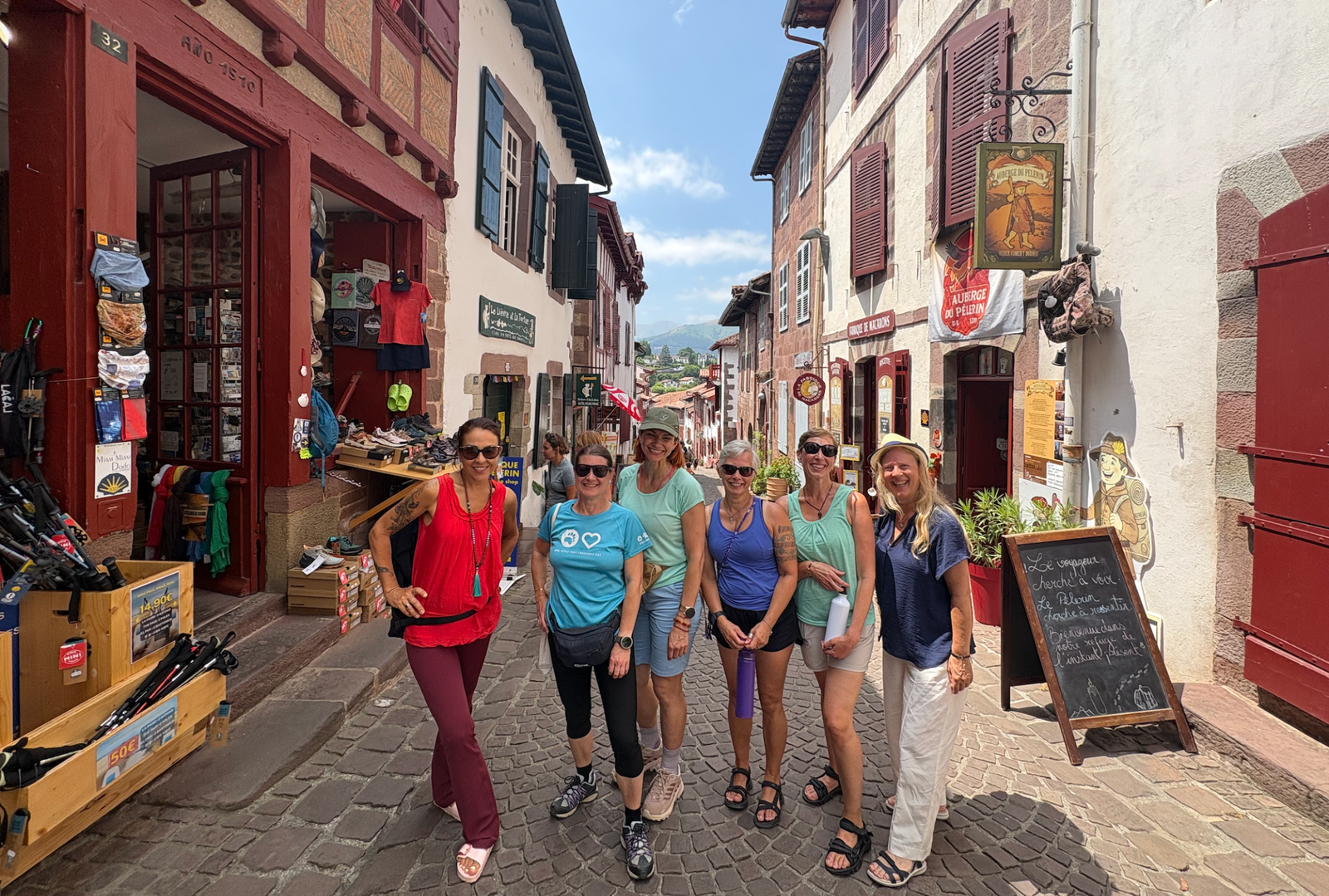 Pilgrims together on a sunny street in Saint-Jean-Pied-de-Port